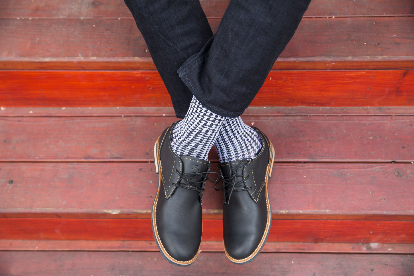 feet dangling showing Rejuva houndstooth compression socks (15-20 mmHg)