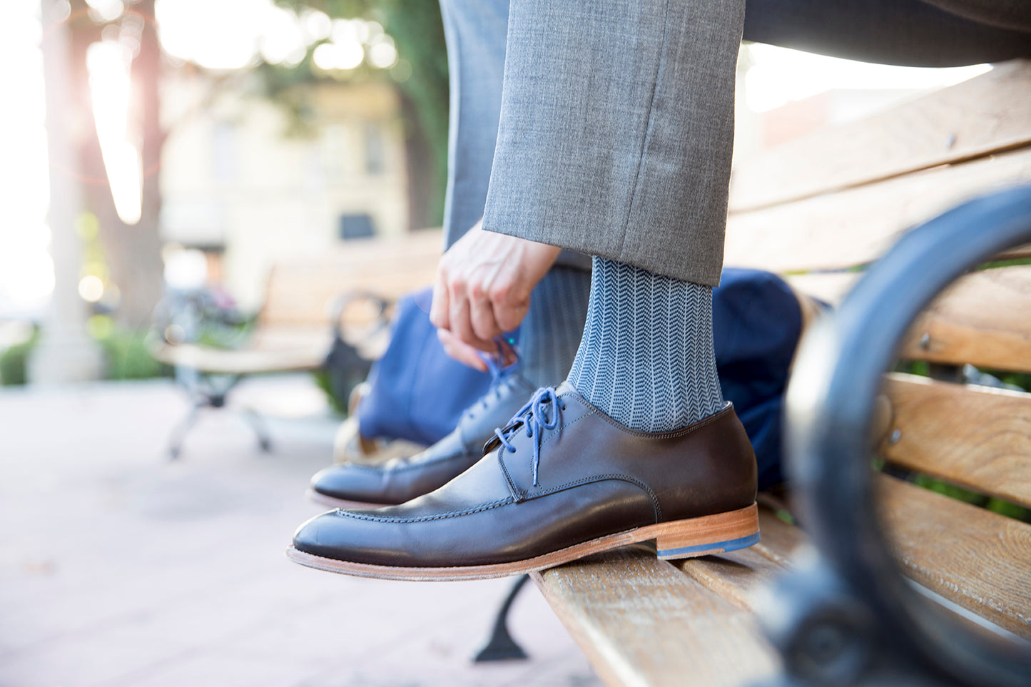 man on park bench in Rejuva herringbone compression socks